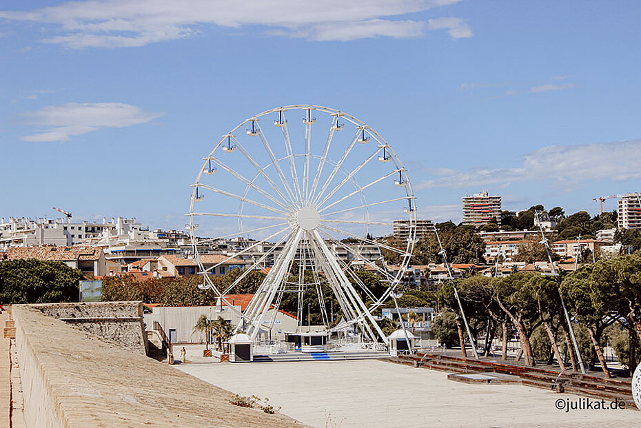 Ein Riesenrad steht auf dem asphaltierten Hafenplatz